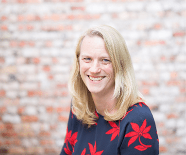 Woman with long blonde hair, smiling warmly
